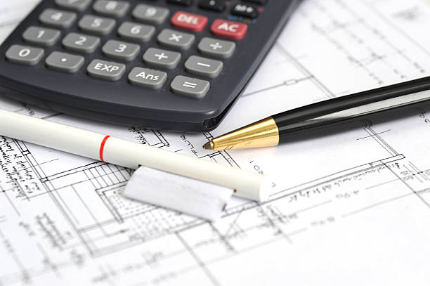 istock blueprints with calculator and pens 182800660