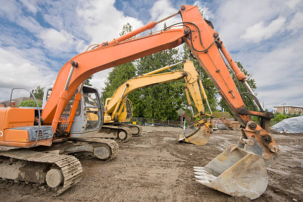 istock Large Trackhoes Lined up at Construction Site 182800771
