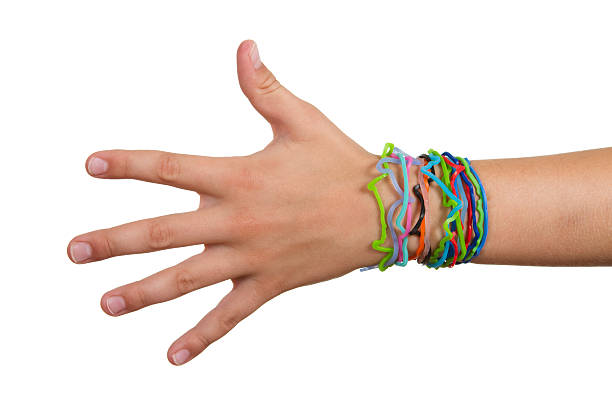 istock Child hand wearing silly shaped rubber band bracelets on arm 182801054