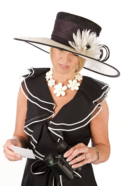 istock Elegantly dressed woman in hat holding binoculars and betting slip 182801258