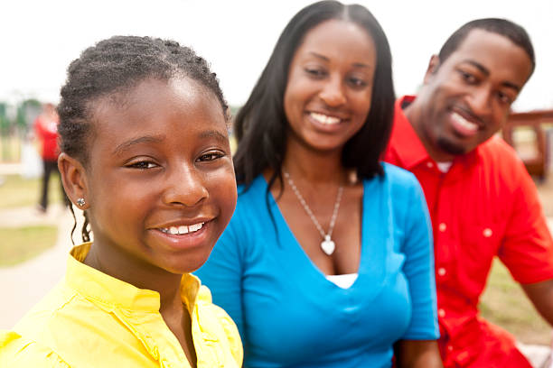 istock Cute Girl With Parents Looking On at a Park 182801517