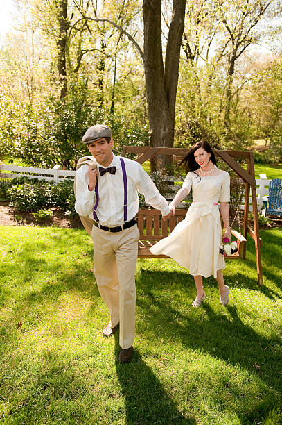istock Retro Bride and Groom hold hands in garden 182801526