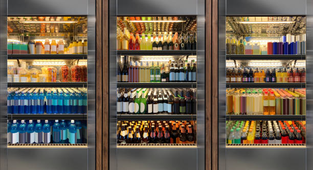 istock Soda pop drinks and soft drinks, beer and wine in vertical elegant refrigerator at airport restaurant Close Up 1828017823