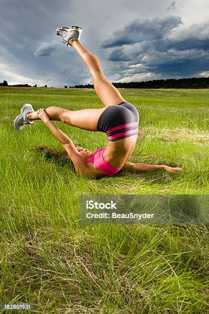 Stretching On Grass Stock Photo - Download Image Now - 20-24 Years, 20-29 Years, Active Lifestyle