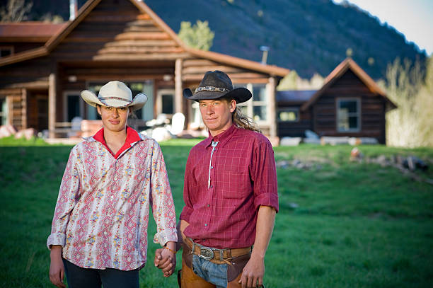 istock Mountain couple standing in front of cabin 182801949