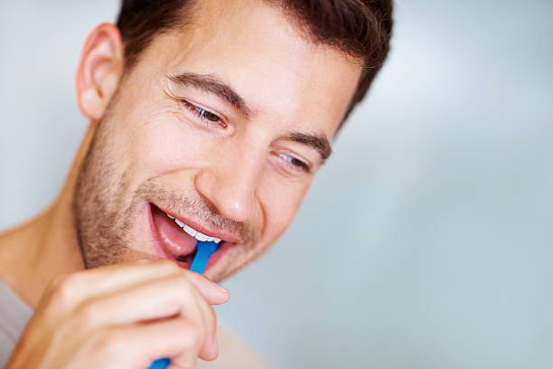 istock Handsome Caucasian male brushing his teeth with copy space 182802150
