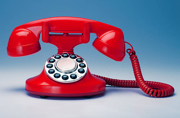 istock Red Old Fashioned Telephone on a Blue Background 182802254