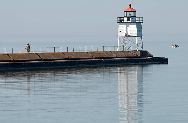 istock Lighthouse at end of concrete pier 182802497