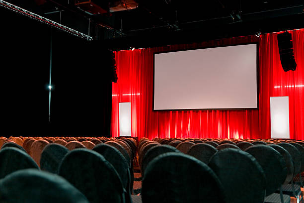 istock Empty large auditorium with a red curtain and blank screen 182802661