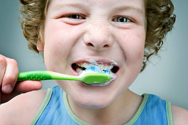 istock Dental Hygiene Young Boy Brushing Teeth 182802779