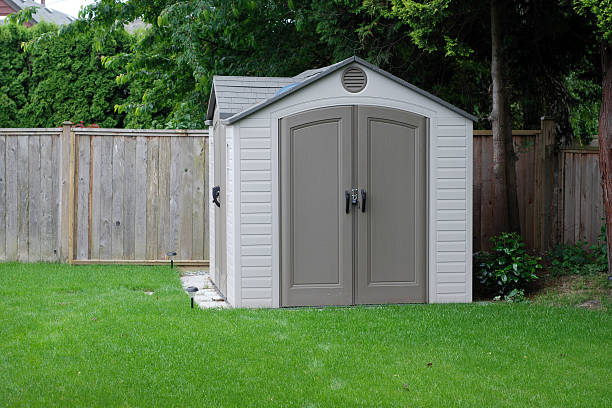 Backyard Shed A small shed in a residential backyard.  See also outdoor shed stock pictures, royalty-free photos & images