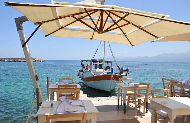 istock Shaded restaurant table and chairs beside the sea at Hersonisos 182803188