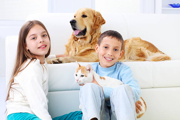 istock Two beautiful children enjoying with pets. 182803565