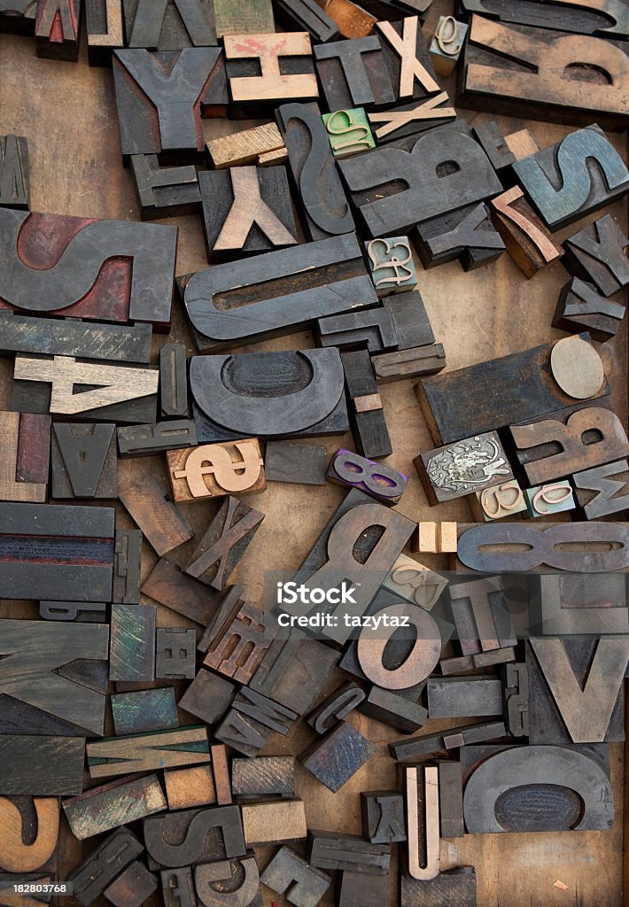 Wooden Letter Press Blocks Randomly strewn wooden letterpress blocks in a wooden box. Overcast day at a flea market. Letterpress Stock Photo