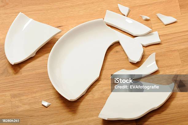A Broken White Ceramic Plate On A Wooden Floor Stock Photo - Download Image Now - Broken, Plate, Ceramics