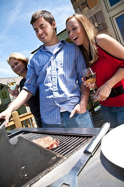 istock Friends Having Fun Grilling Steaks on House Patio Grill 182804566
