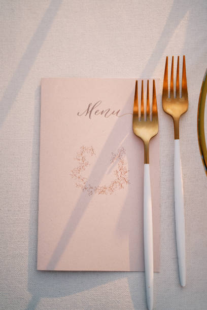 istock Festive menu lies under the cutlery on a white tablecloth on the table 1828050575
