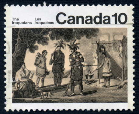 A ten cent Canadian postage stamp issued in 1976 depicting an Iroquois encampment.