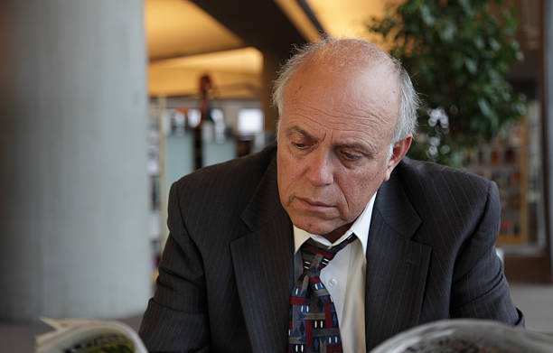 istock Senior Man Looking Over Newspaper 182805088
