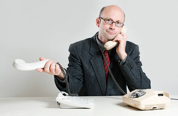 istock Businessman with two telephones 182805170