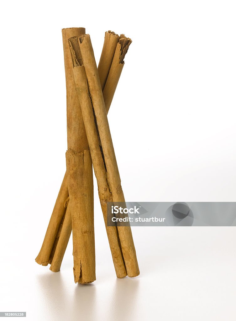 cinnamon stick three standing cinnamon sticks with refection Cinnamon Stock Photo