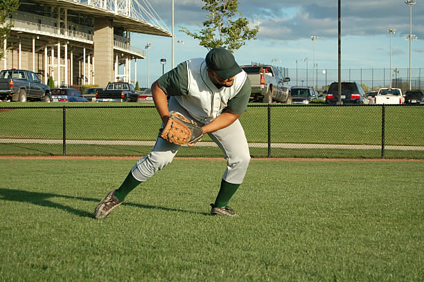 Outfielder Returns a Grounder Outfielder returns a ground ball.Also: fielding drills for baseball stock pictures, royalty-free photos & images