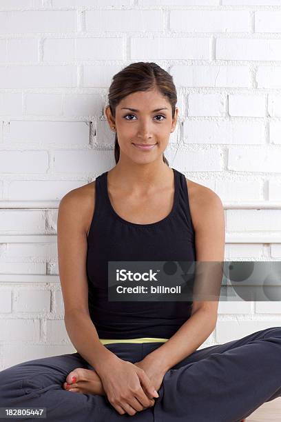 Young Attractive Woman Relaxing With Legs Crossed Stock Photo - Download Image Now - Jogging Pants, One Woman Only, Women