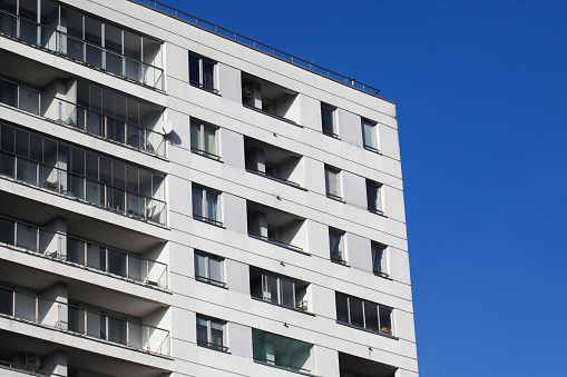 Block of flats isolated on blue sky.