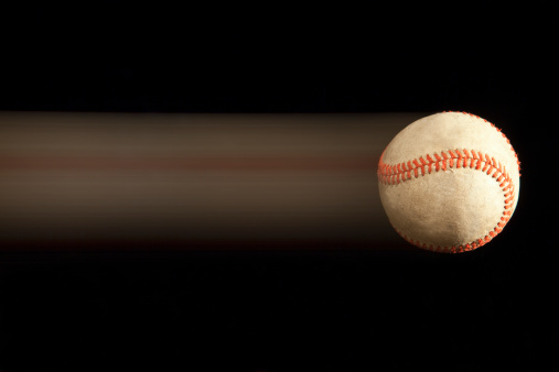 Baseball on black background with motion blur.