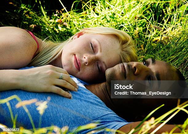 Romantic Young Couple Lying In The Grass Stock Photo - Download Image Now - Lying Down, Nature, Relaxation
