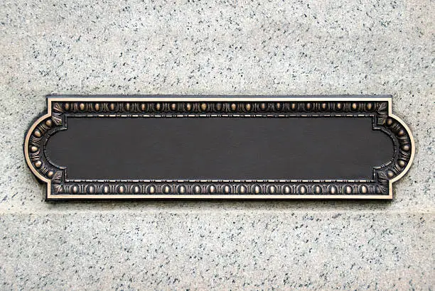 Brass plaque with copy space mounted on a wall.