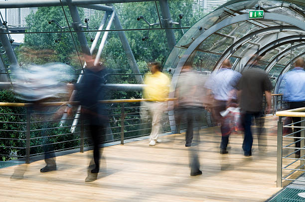 istock Pedestrians Walking Through Walkway in Modern Glass Building, Blurred Motion 182806426