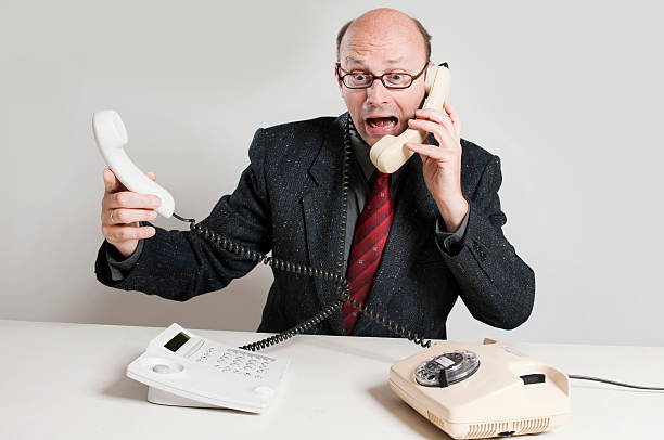 istock Businessman shouting in receiver 182806634