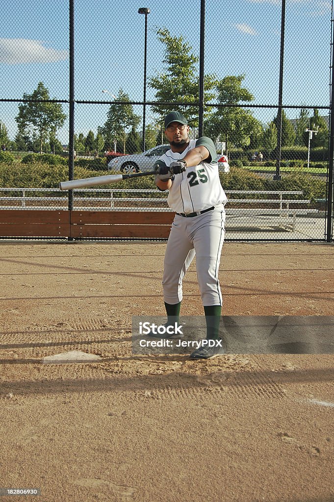At Bat Batter swings in preparation for the pitch.Also: Softball - Sport Stock Photo
