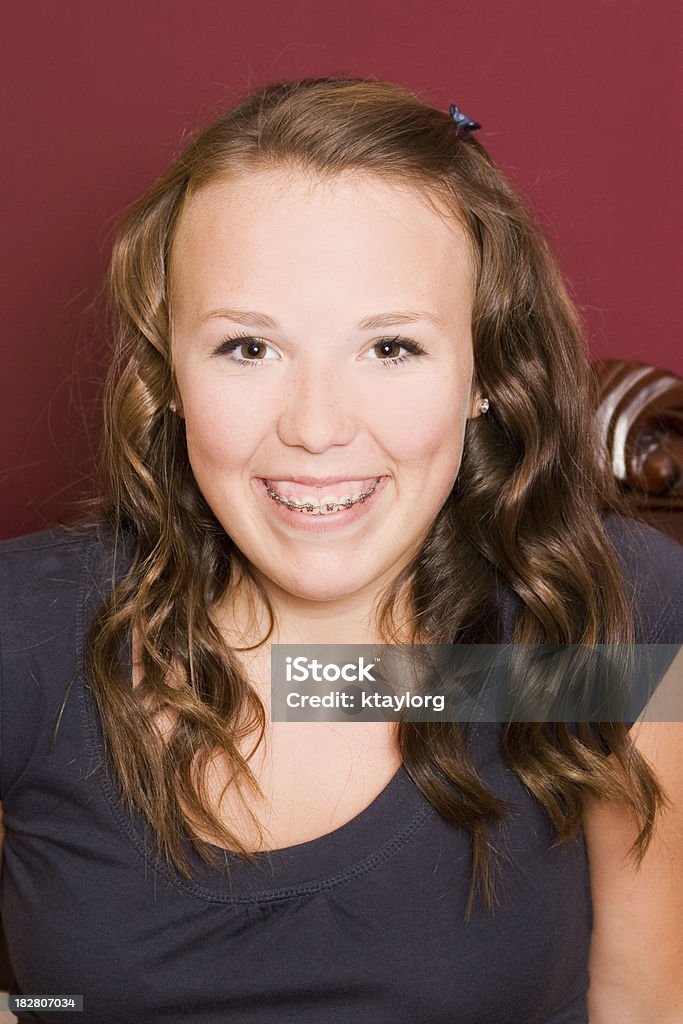 Happy Teenage Girl with braces Cute teen with long hair and braces Adolescence Stock Photo