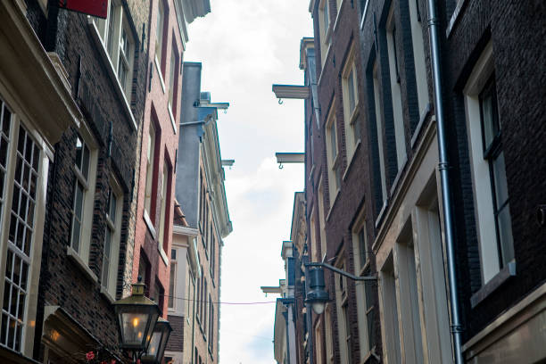 istock Narrow street between old city buildings 1828077844