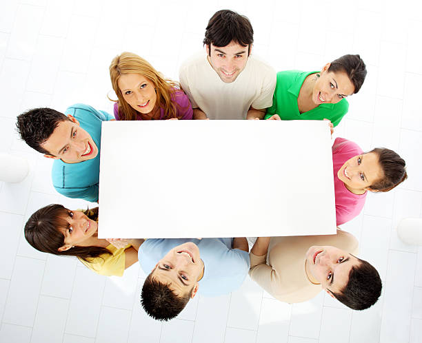 istock Group of people holding blank board and looking up. 182807917