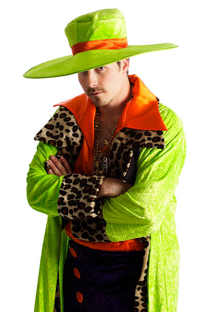 Brightly Dressed Man A white background portrait of a young man wearing brightly colored clothing staring at the camera. pimp hat stock pictures, royalty-free photos & images