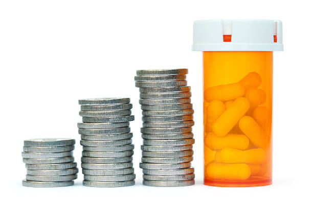 Expensive drugs Coin rolls and pill bottle. prescription medicine stock pictures, royalty-free photos & images