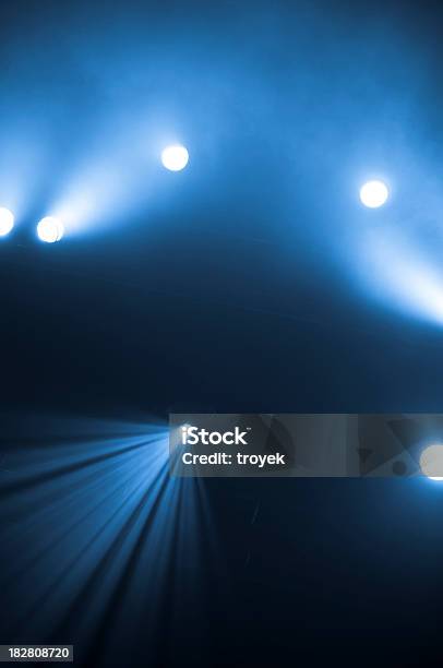 Bright Spotlights Shining On Stage With Blue And Black Hues Stock Photo - Download Image Now