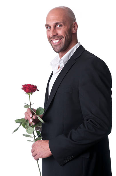 istock smiling man holding a single red rose 182809138
