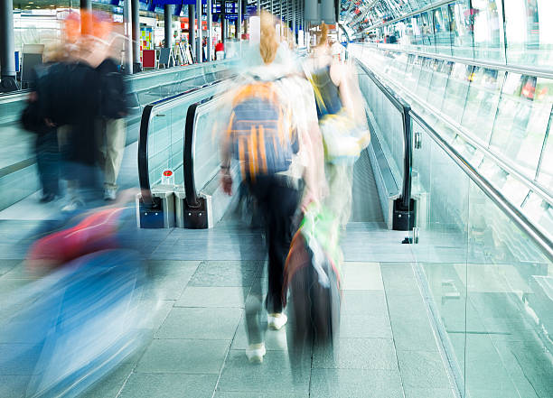 istock Travellers Entering Moving Walkway at Airport, Blurred Motion 182809235
