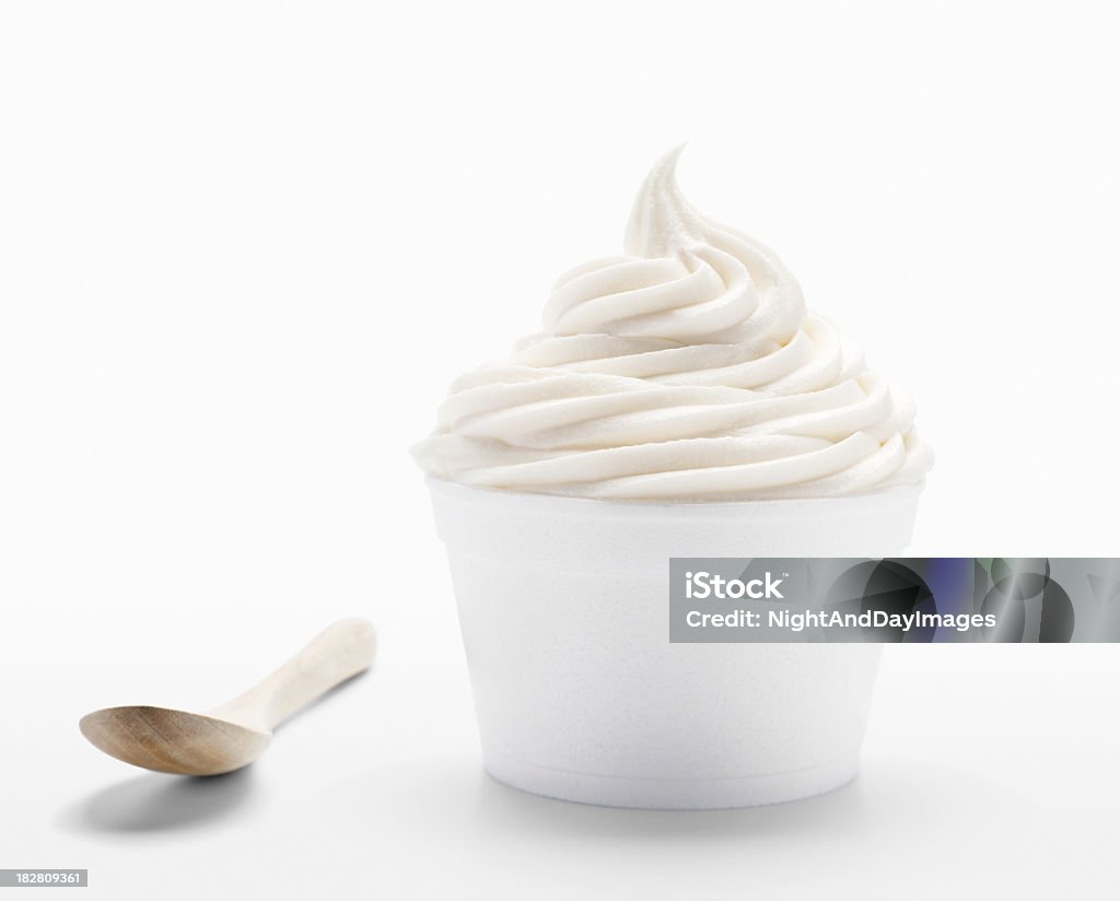 Frozen soft serve yogurt in XXXL SEVERAL MORE IN THIS SERIES. Cup of plain vanilla frozen yogurt or soft serve ice cream with an eco-spoon made of bamboo.   High resolution XXXL image with various crops possible. Cup Stock Photo