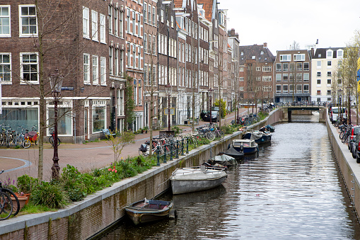 Row of houses by the side of a small canal in Amsterdam
