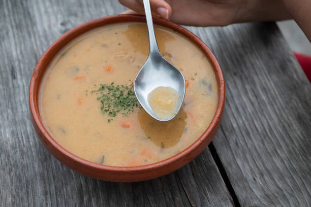 istock A Bowl of mushrooms soup with a spoon, top view 1828101764
