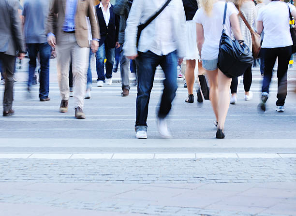 istock Motion blurred pedestrians crossing street 182810577