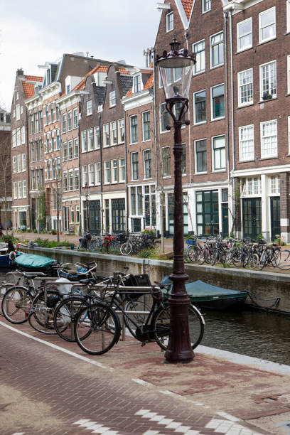 istock Bicycles and a street light by an Amsterdam canal 1828106582