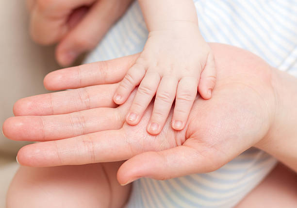 istock hands -  baby and parents 182810973