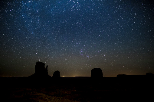 constellation orion rising above Monument Valley, West Mitten Butte, East Mitten Butte and Merrick Butte, Arizona, Utah, USA