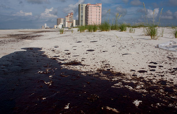 istock Oil on beach sand from oil spill 182811072